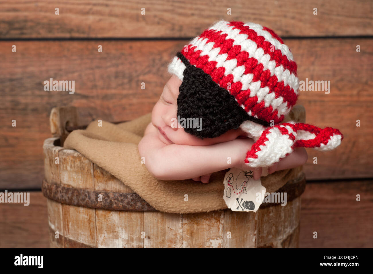 Newborn Baby Boy Wearing a Pirate Hat and Eye Patch Stock Photo