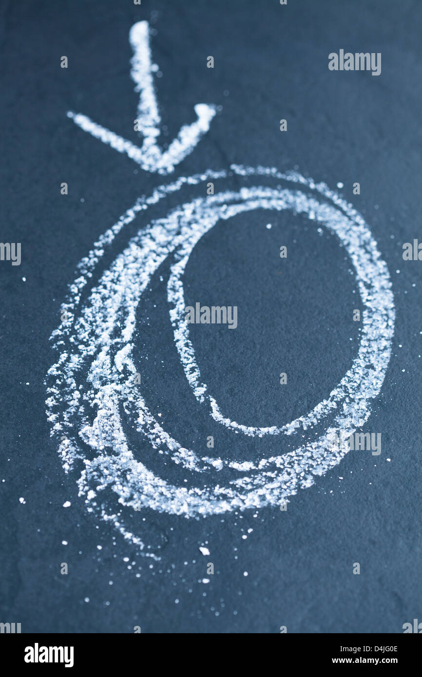 Closeup of chalk drawing of spiraling circles and arrow pointing to it Stock Photo