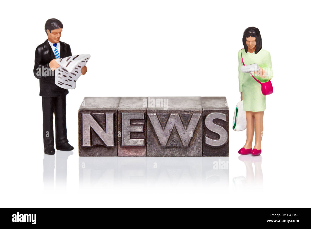 Hand painted business figurines and the word NEWS in old metal letterpress isolated on a white background. Stock Photo