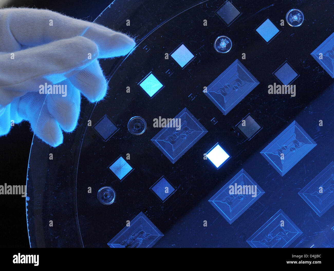 The picture shows a so-called Mini Laboratory, in the size of a stamp, developed in a new hot stamping process by Jenoptik?s Optical Systems branch in Jena, Germany, 12 February 2009. Finest structures in the nanometre spectrum can be cost-efficiently produced with this new technology. Such microstructured optical components are used in e.g. medical diagnosis or agent research. Pho Stock Photo