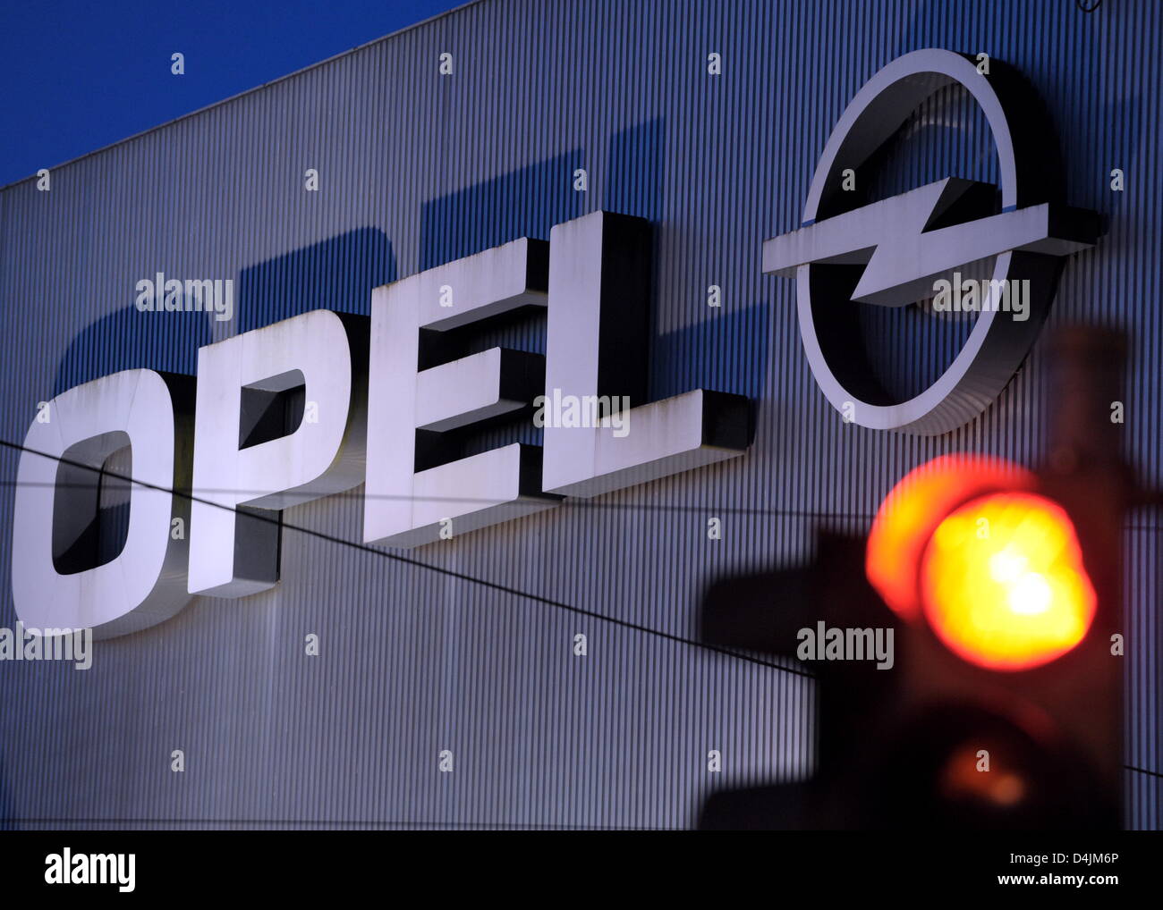 A red light is pictured against the background of the Opel logo in ...