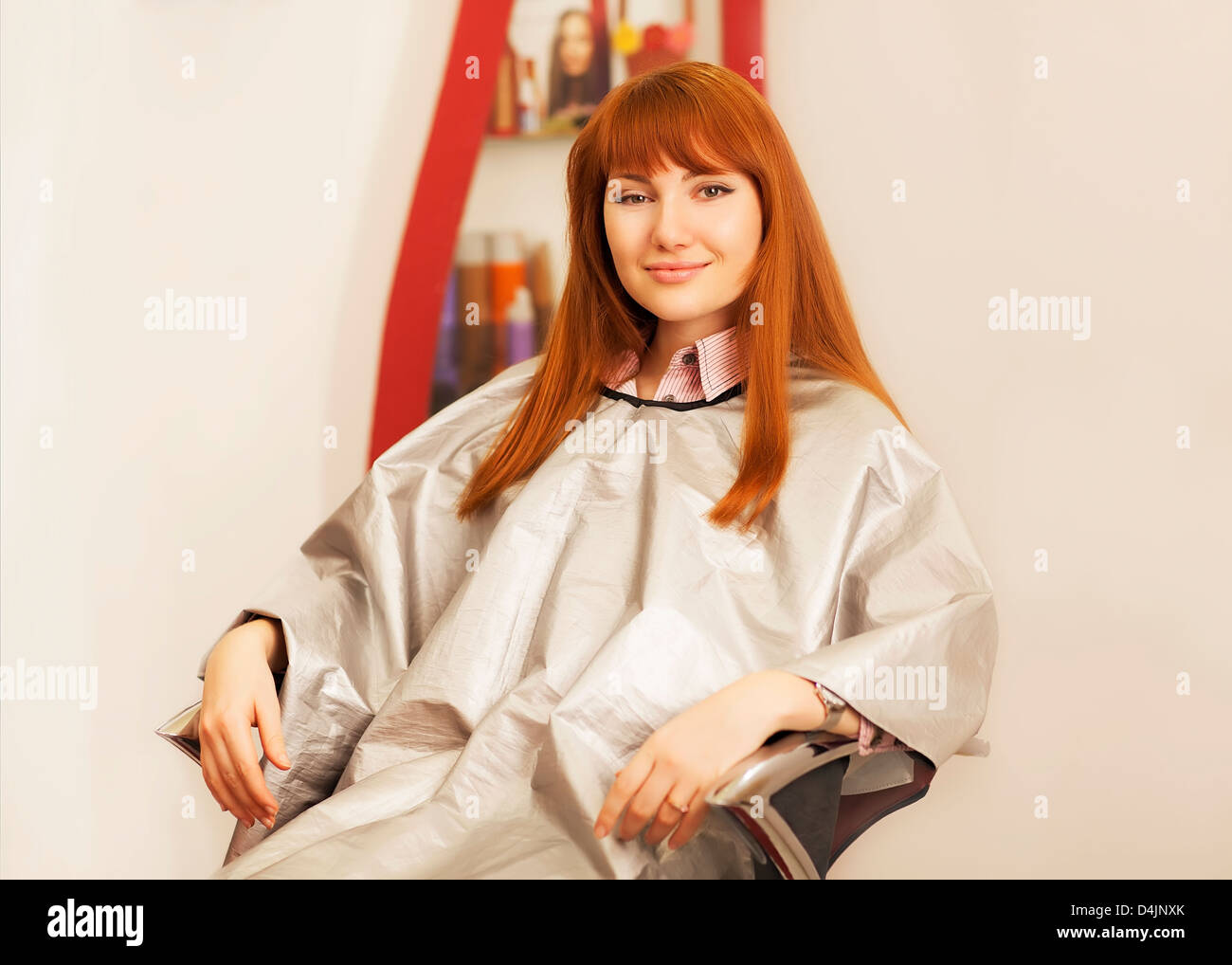 Cute young woman having her hair trimmed by a stylist Stock Photo