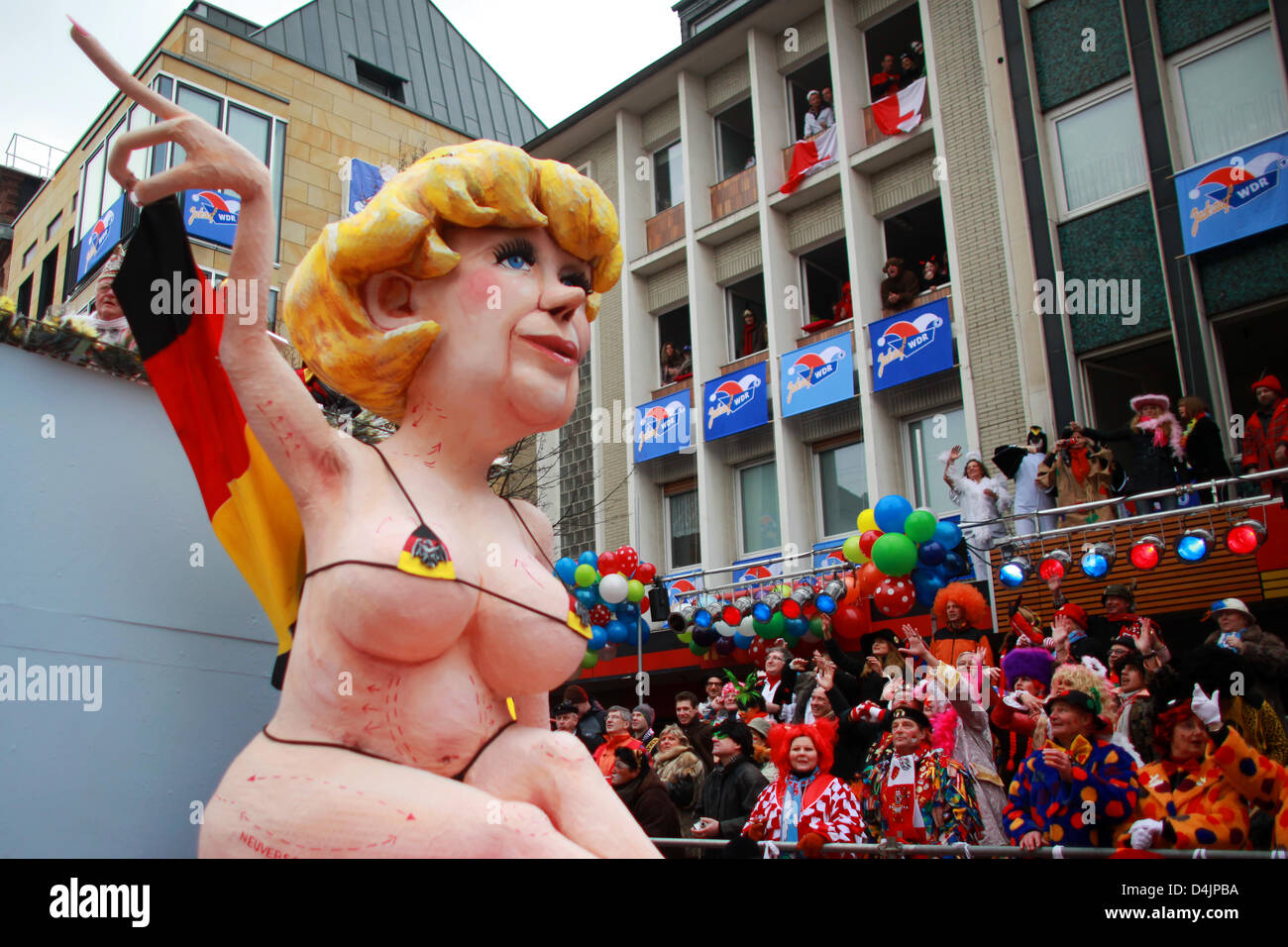 A float with an optically ?upgraded? version of German Chancellor Merkel is paraded through the streets on Shrove Monday in Cologne, Germany, 23 February 2009. On Shrove Monday tens of thousands carnival goers celebrate in the streets of Duesseldorf, Cologne and other carnival strongholds. Photo: Rolf Vennenbernd Stock Photo