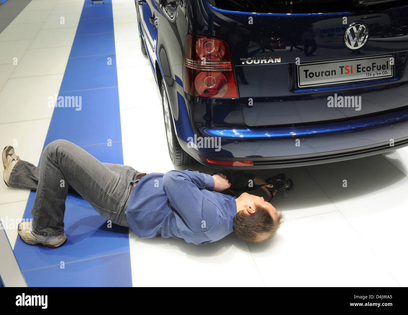 A man takes pictures of a VW Touran TSI EcoFuel on the second press day of  the 79th International Motor Show and Accessories on the Palexpo premises  in Geneva, Switzerland, 04 March