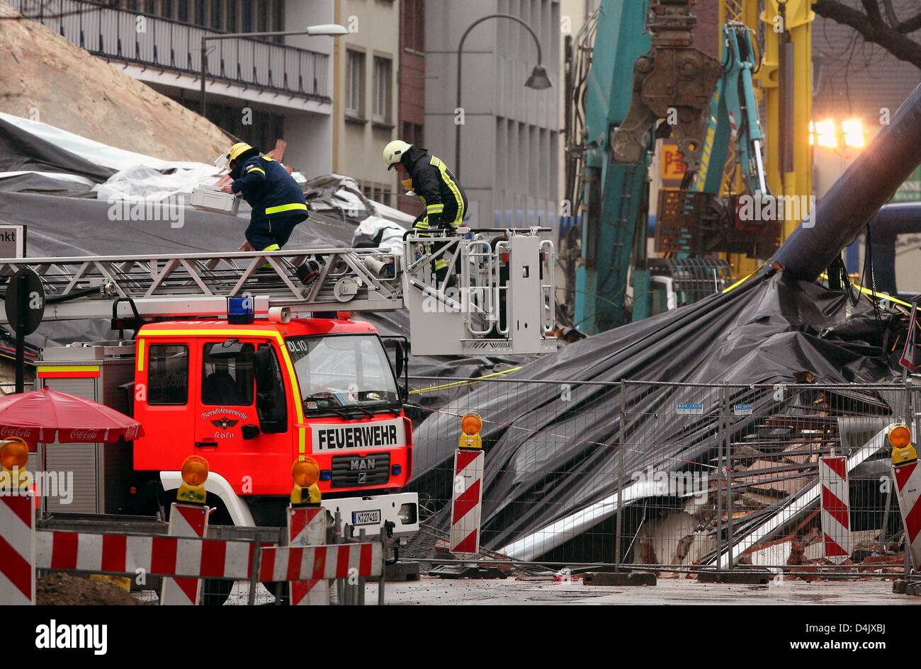 Firefighters operate a fire ladder above Cologne?s collapsed Historic