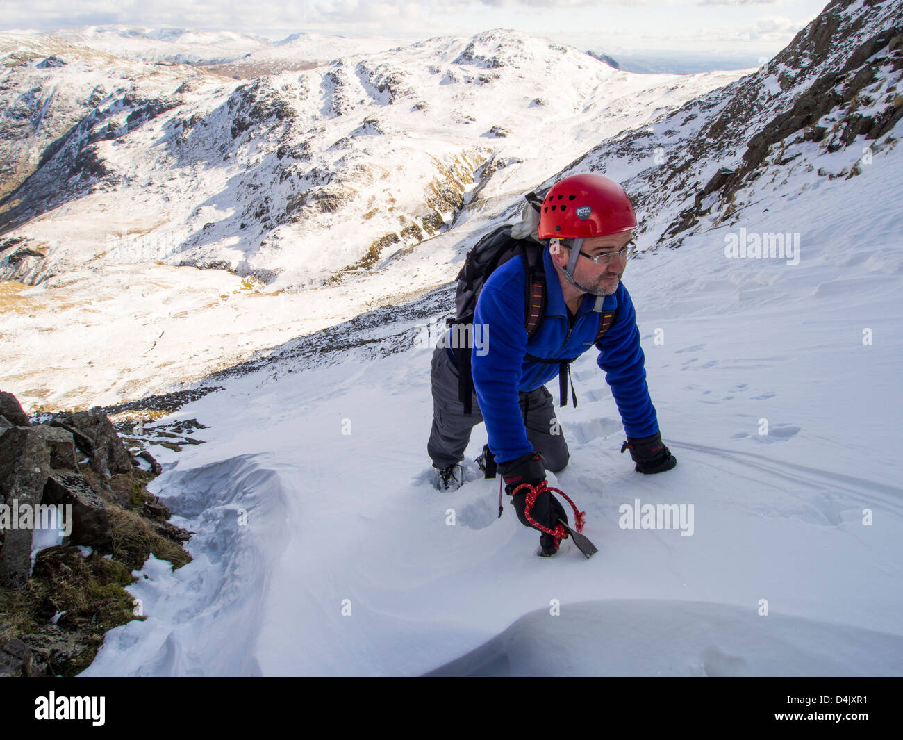 A climber in Custs Gully on Great End, a grade one winter route, Lake District, UK. Stock Photo