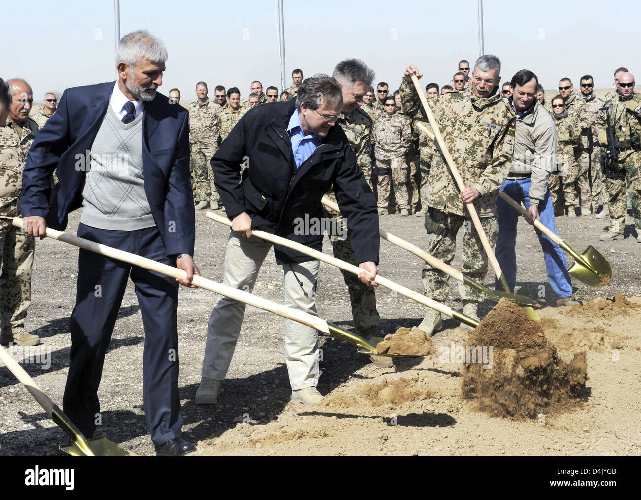 (L-R) Afghan Vice Transport Ministerm, Mr Alami, German Defence Minister Franz Josef Jung, the assistant chief of staff at the ISAF headquarters, Hans-Erich Antoni, and ISAF Commander North, Joerg Vollmer perform the ground breaking ceremony for the new runway at the airport in Masar-i-Scharif, Afghanistan, 10 March 2009. The new runway for the designated air traffic hub will be 3, Stock Photo