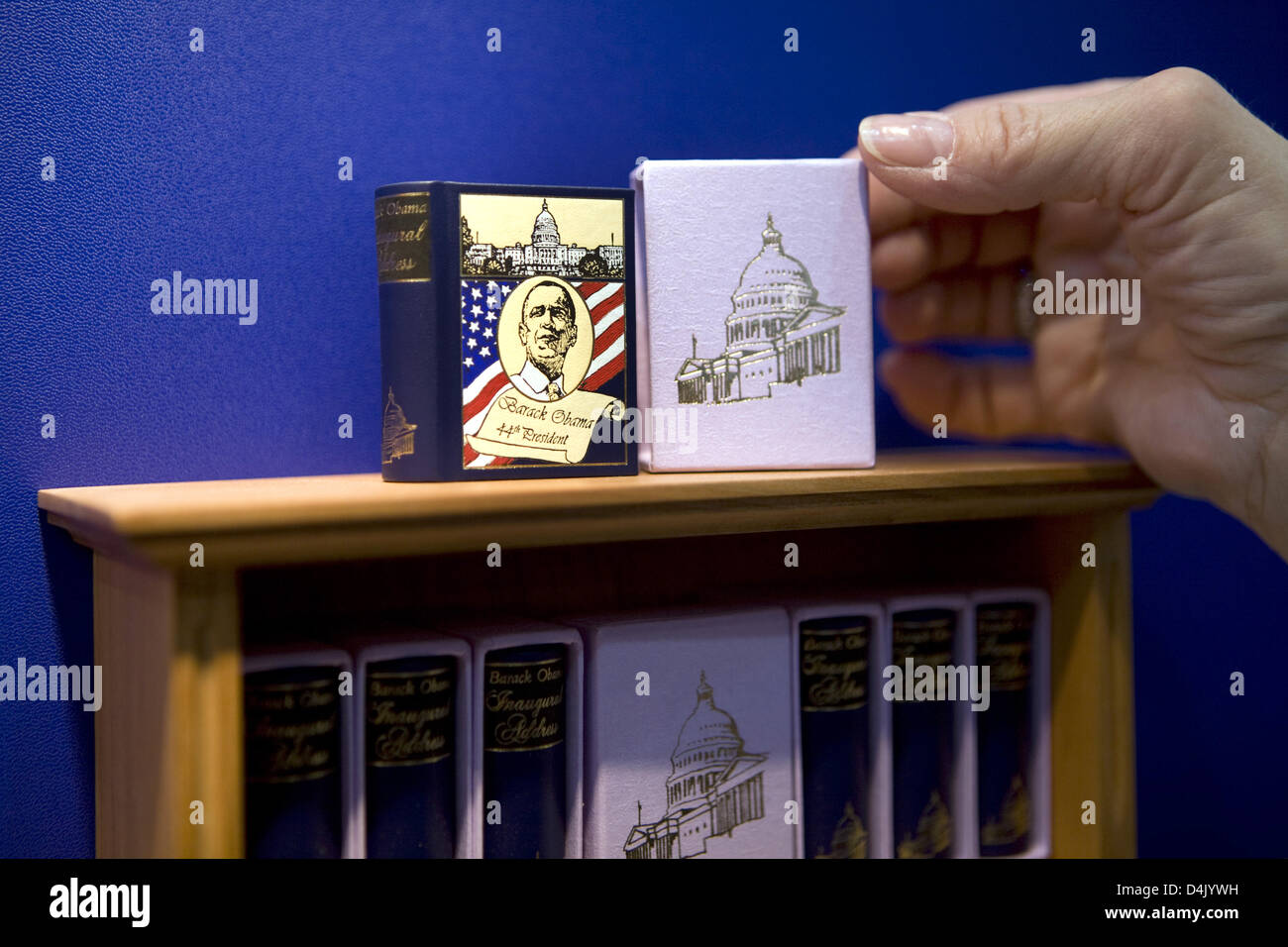A member of staff of the miniature book publisher Leipzig presents a miniature edition of the US Constitution, the Declaration of Independence and the inaugural adress of the 44th President Barack Obama at the opening day of the Leipzig Book Fair 2009 in Leipzig, Germany, 12 March 2009. From 12 to 15 March, 2.135 exhibitors from 38 countries present novelties from the book market a Stock Photo