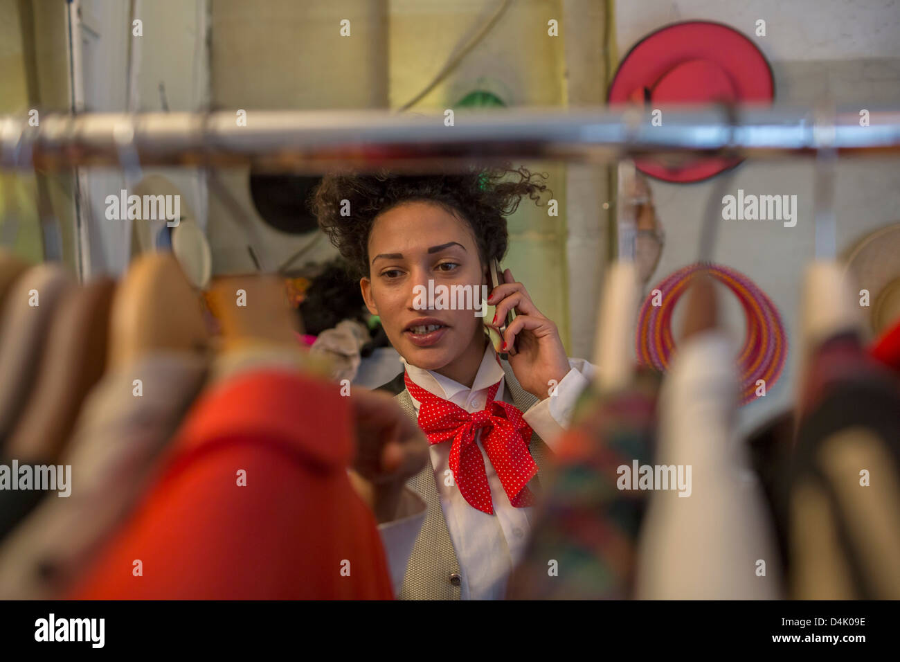 Woman on cell phone in clothes shop Stock Photo