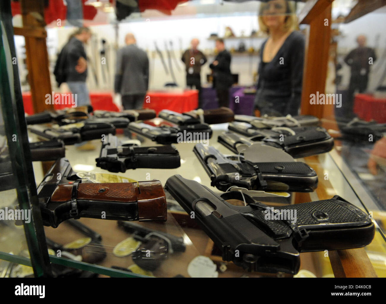 Officer?s pistols lie in the locked showcase of an exhibitor at the International Arms Fair in Sindelfingen, Germany, 14 March 2009. After the ramage shooting in Winnenden and Wendlingen with 16 dead, Sindelfingen tried to prevent the fair from taking place. The administration court in Stuttgart refused an interdiction of the fair, however. Photo: Norbert Foersterling Stock Photo