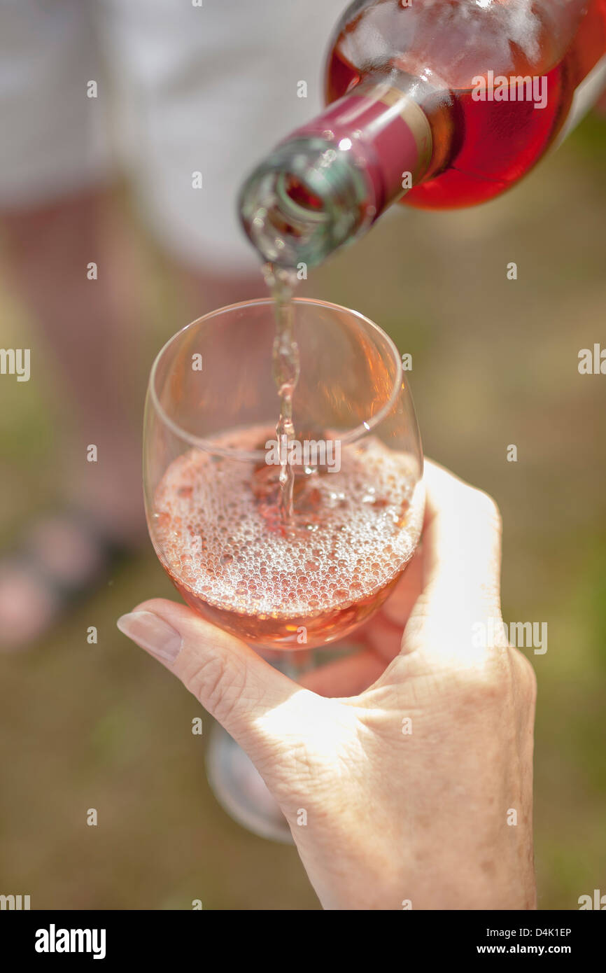 Woman pouring glass of wine outdoors Stock Photo - Alamy