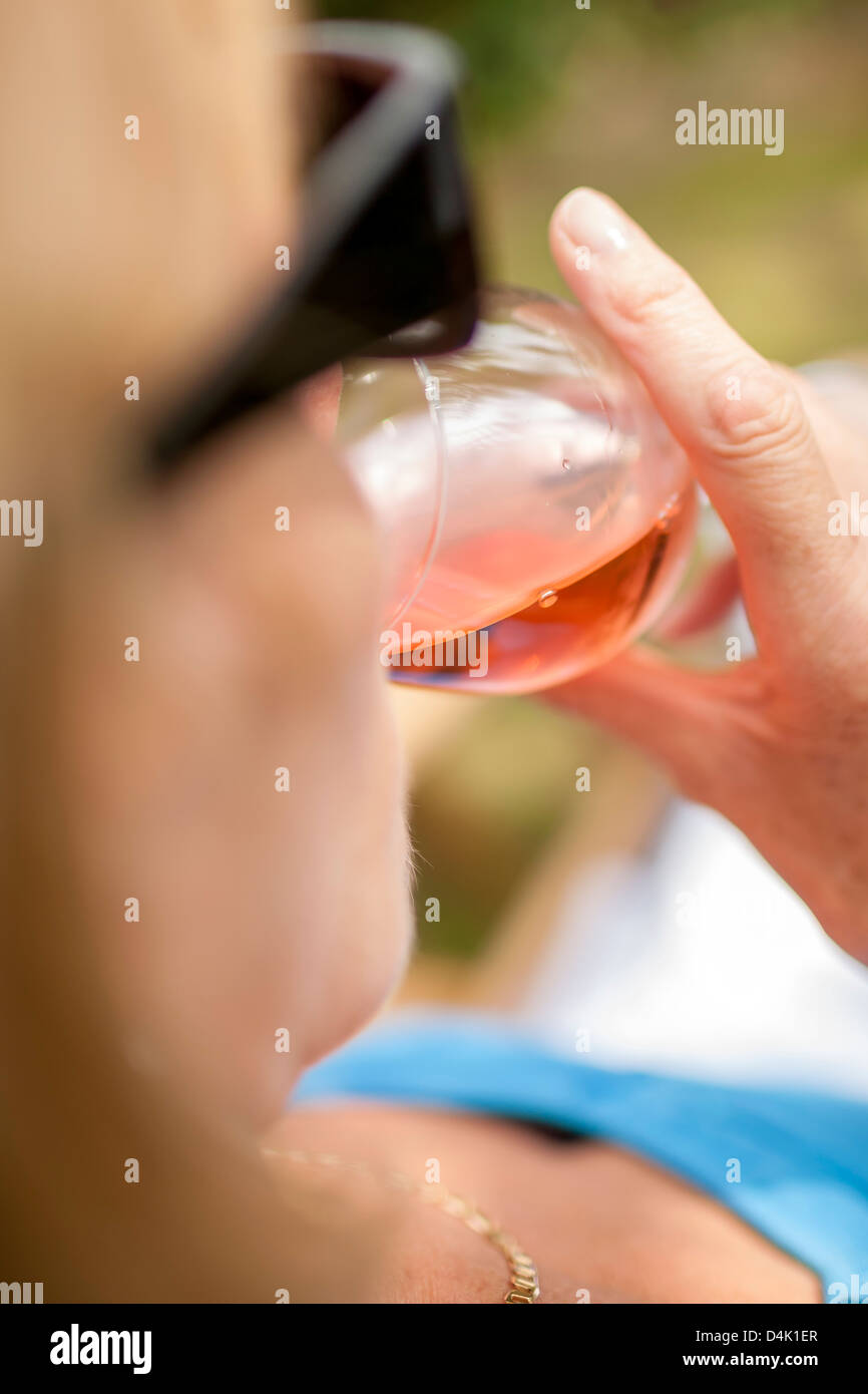 Woman drinking glass of wine outdoors Stock Photo