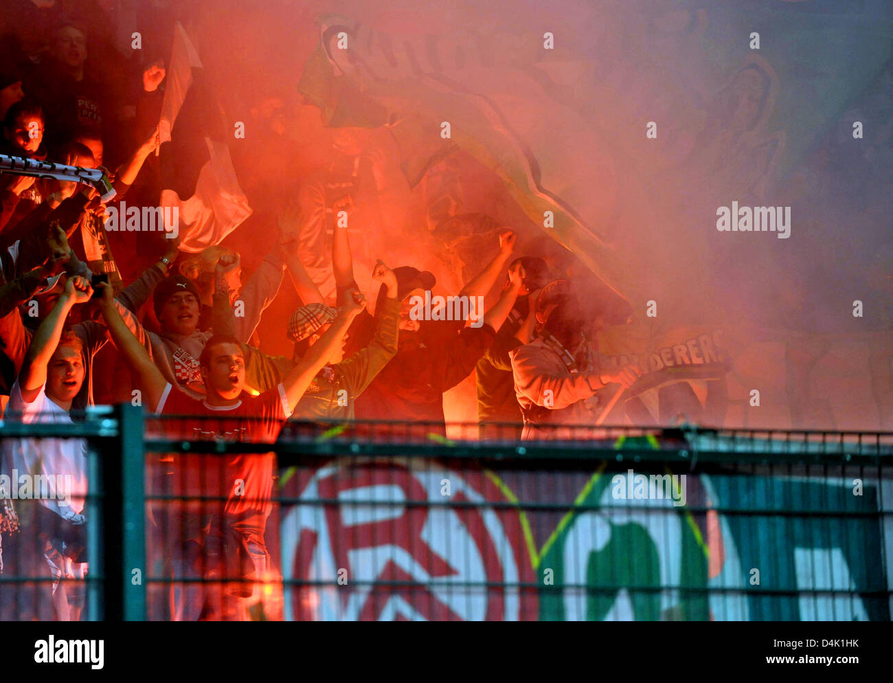 Fans of Werder Bremen light fireworks during the UEFA Cup last sixteen return match against AS Saint-Etienne at Stadium Geoffroy Guichard in Saint Etienne, France, 18 March 2009. The game ended in a 2-2 tie with Bremen qualifying for the quarter-finals. Photo: Carmen Jaspersen Stock Photo