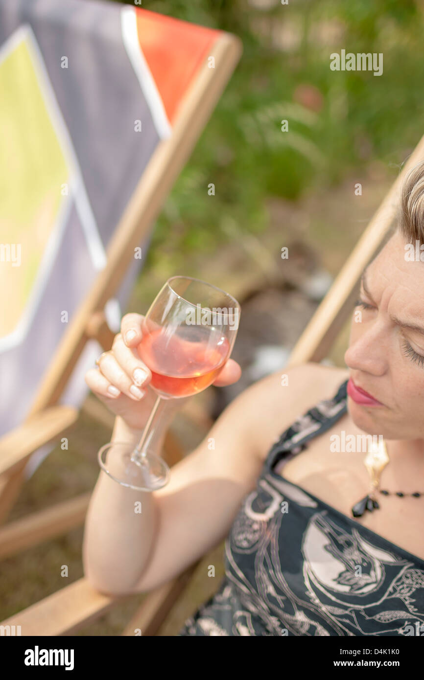 Woman having glass of wine outdoors Stock Photo