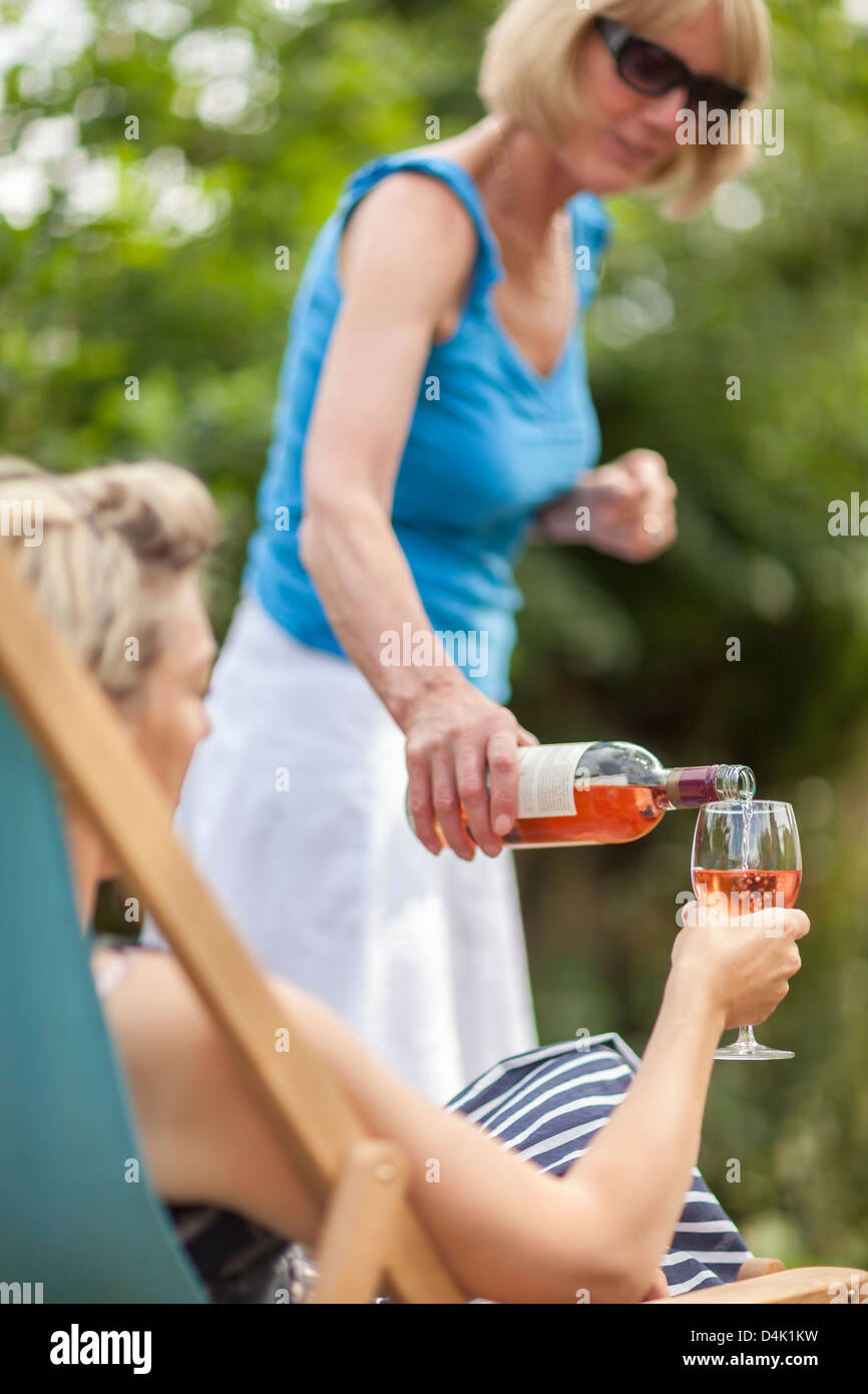 Women having wine together outdoors Stock Photo