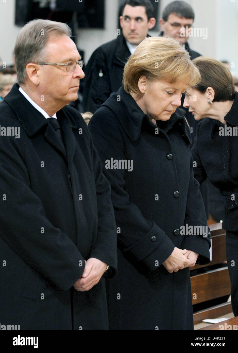 German Chancellor Angela Merkel (R) and the President of the Federal Constitutional Court, Hans-Juergen Papier (L) attend the official memorial service at St. Karl Borromaeus Church in Winnenden, Germany, 21 March 2009. Mourners commemorated the 15 vicitims killed during the rampage shooting at secondary school ?Albertville? in Winnenden and Wendlingen on 11 March 2009, when 17-yea Stock Photo