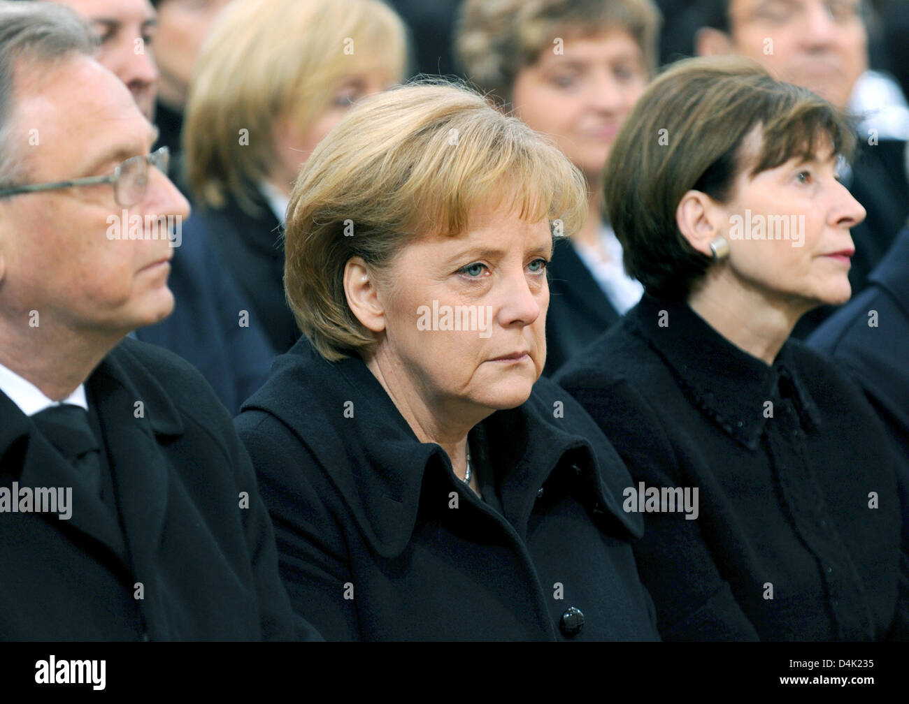 German Chancellor Angela Merkel (C), the President of the Federal Constitutional Court, Hans-Juergen Papier (L) and Eva Luise Koehler (R), wife of Germany?s President, attend the official memorial service at St. Karl Borromaeus Church in Winnenden, Germany, 21 March 2009. Mourners commemorated the 15 vicitims killed during the rampage shooting at secondary school ?Albertville? in W Stock Photo