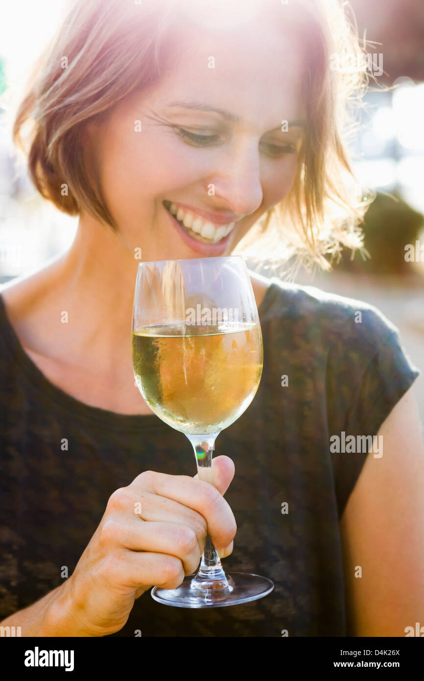 Woman having glass of wine outdoors Stock Photo