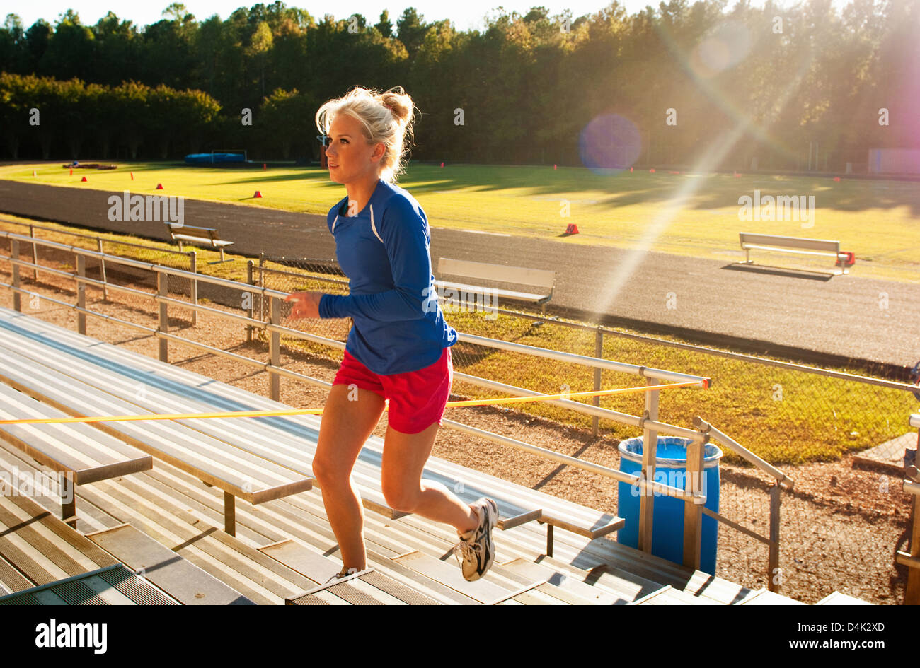 Woman running up bleacher steps Stock Photo Alamy