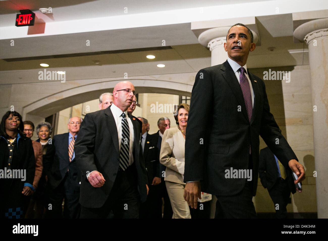 Washington DC, USA. 14th March 2013. United States President Barack Obama, walking with U.S. House Democratic Leader Nancy Pelosi (Democrat of California - C), leaves a meeting at the U.S. Capitol with the House Democratic Caucus, on Capitol Hill in Washington, Thursday, March 14, 2013. Earlier in the day, President Obama also met with the Senate Republican Conference. .Credit: Drew Angerer / Pool via CNP/dpa/Alamy Live News Stock Photo
