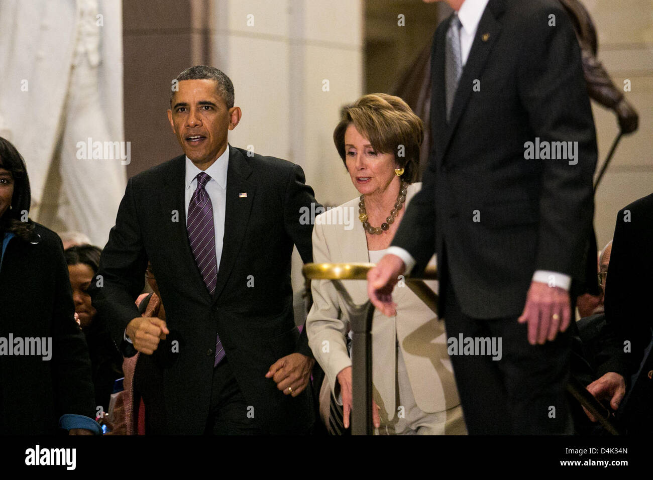 Washington DC, USA. 14th March 2013. United States President Barack Obama, walking with U.S. House Democratic Leader Nancy Pelosi (Democrat of California), leaves a meeting at the U.S. Capitol with the House Democratic Caucus, on Capitol Hill in Washington, Thursday, March 14, 2013. Earlier in the day, President Obama also met with the Senate Republican Conference. .Credit: Drew Angerer / Pool via CNP/dpa/Alamy Live News Stock Photo