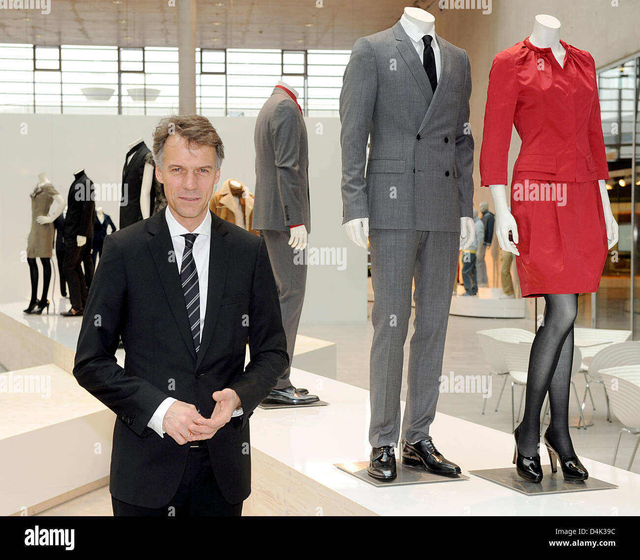 Claus-Dietrich Lahrs, CEO of fashion label Hugo Boss, poses with mannequins  prior to the balance press conference in Metzingen, Germany, 26 March 2009.  For Hugo Boss, declining consumption has brought about a