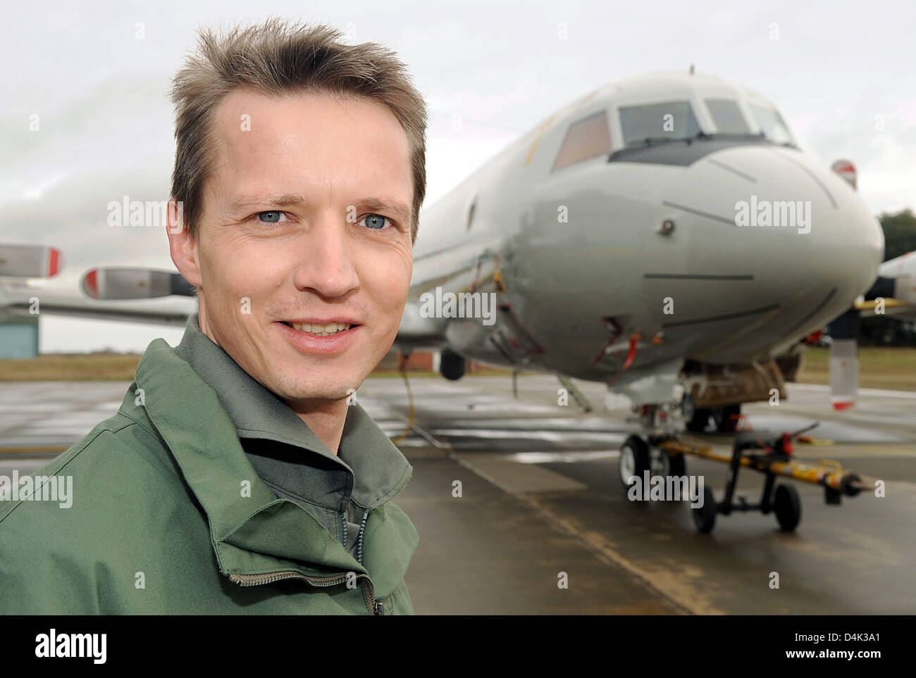 Frigate captain Mario Kaiser introduces himself as new commander of the German soldiers in Djibouti at the Horn of Africa while posing at the German navy air base MFG 3 in Nordholz, Germany, 26 March 2009. The Maritime Patrol Aircraft of type P-3C Orion (background) will replace the German frigate ?Mecklenburg-Vorpommern? as of April in fighting international terrorism within the s Stock Photo