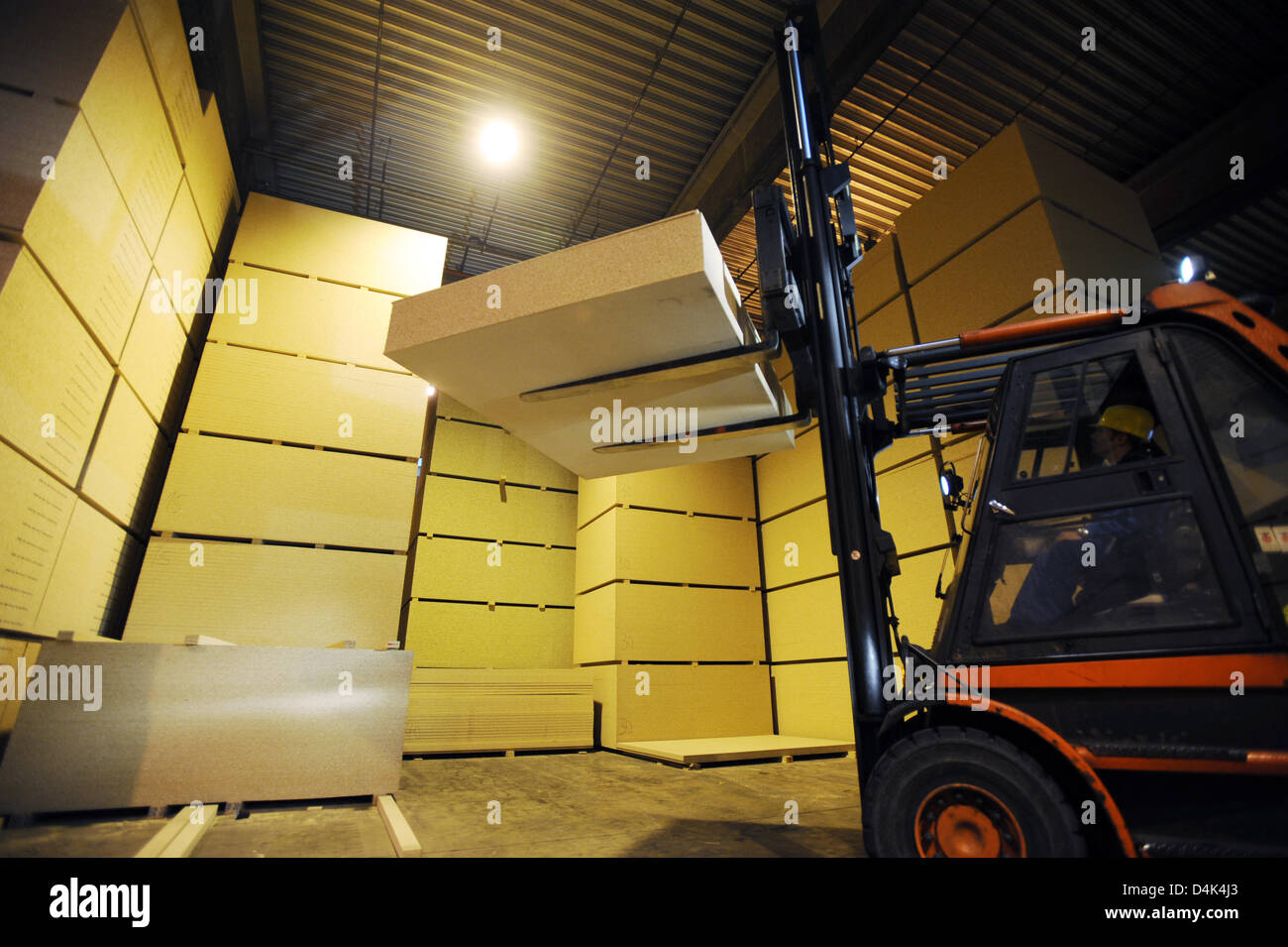 A Forklift Transports Chipboards In A Warehouse Of Pfleiderer Ag