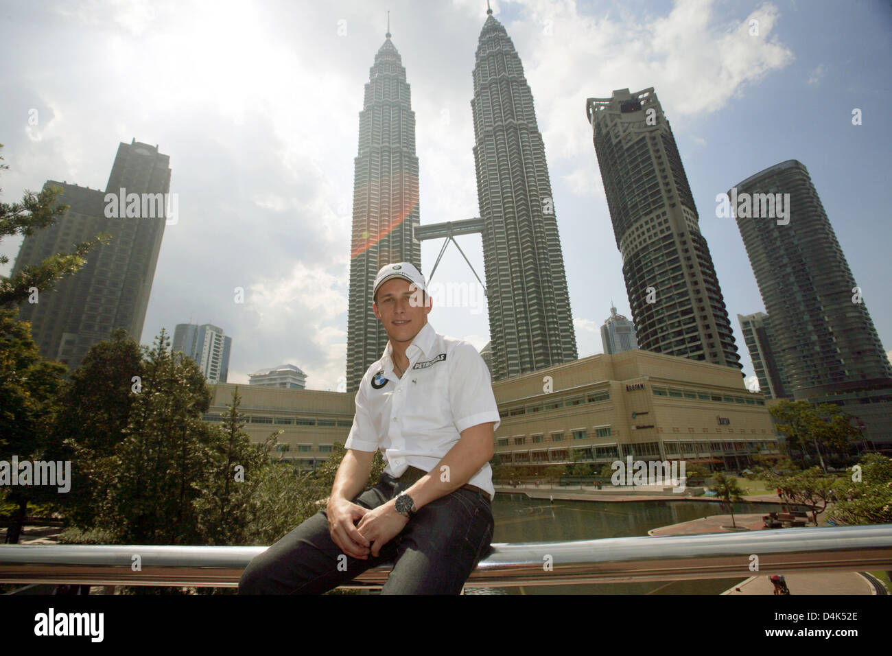 Austrian Formula One test driver Christian Klien of BMW Sauber poses in front of the Petronas Towers in Kuala Lumpur, Malaysia, 01 April 2009. The Formula One Malaysian Grand Prix will take place at Sepang International Circiut near Kuala Lumpur on 05 April 2009. Photo: JENS BUETTNER Stock Photo