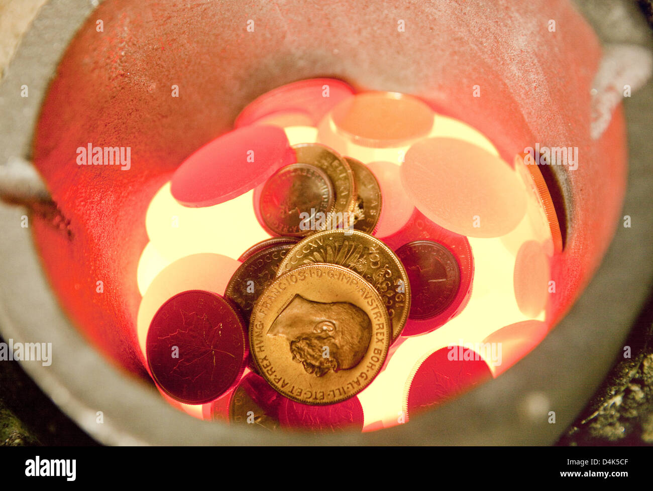 Old gold coins are melted down in a melting pot at the Heraeus gold