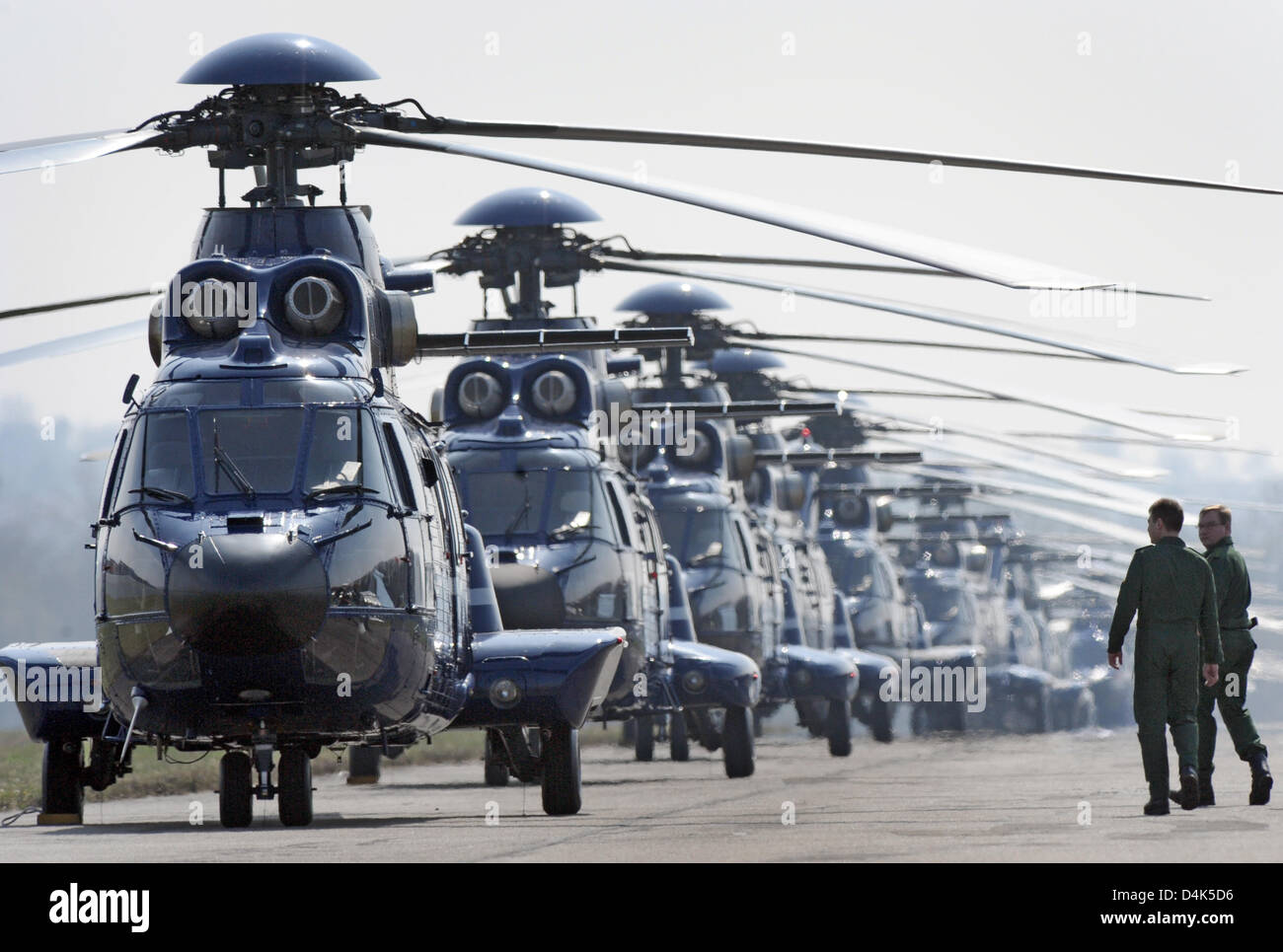 A long row of helicopters of the type ?Super-Puma? stands on an airport near Offenburg, Germany, 02 April 2009. In case of emergency, they can start within a few minutes and bring special units or delegations to their place of destination. Photo: Boris Roessler Stock Photo