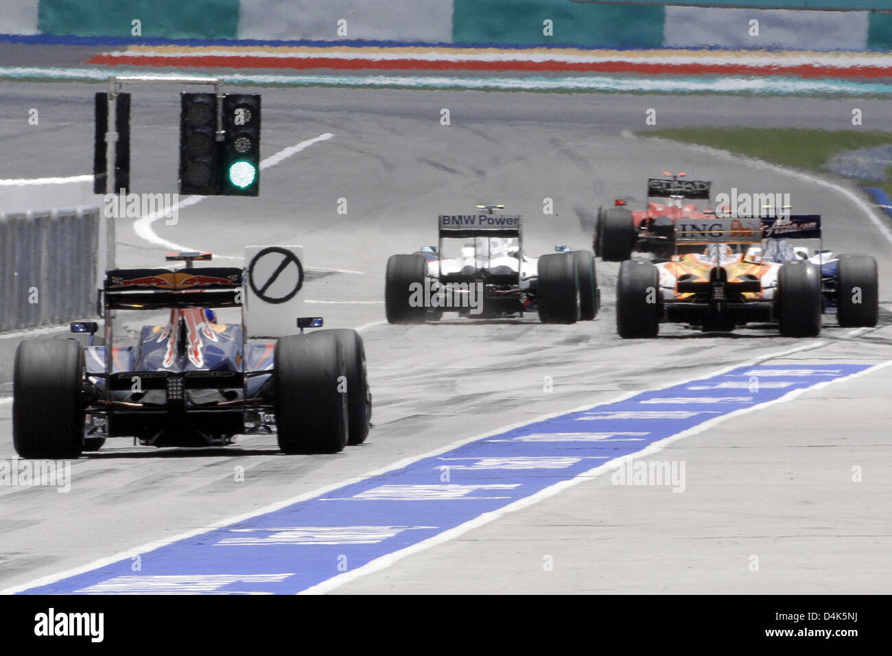 Drivers steer their cars onto the track during the second  training at Sepang circuit on the outskirts of Kuala Lumpur, Malaysia, 03 April 2009. The 2009 Formula One Malaysian Grand Prix will take place on Sunday 05 April. Photo: Jens Buettner Stock Photo