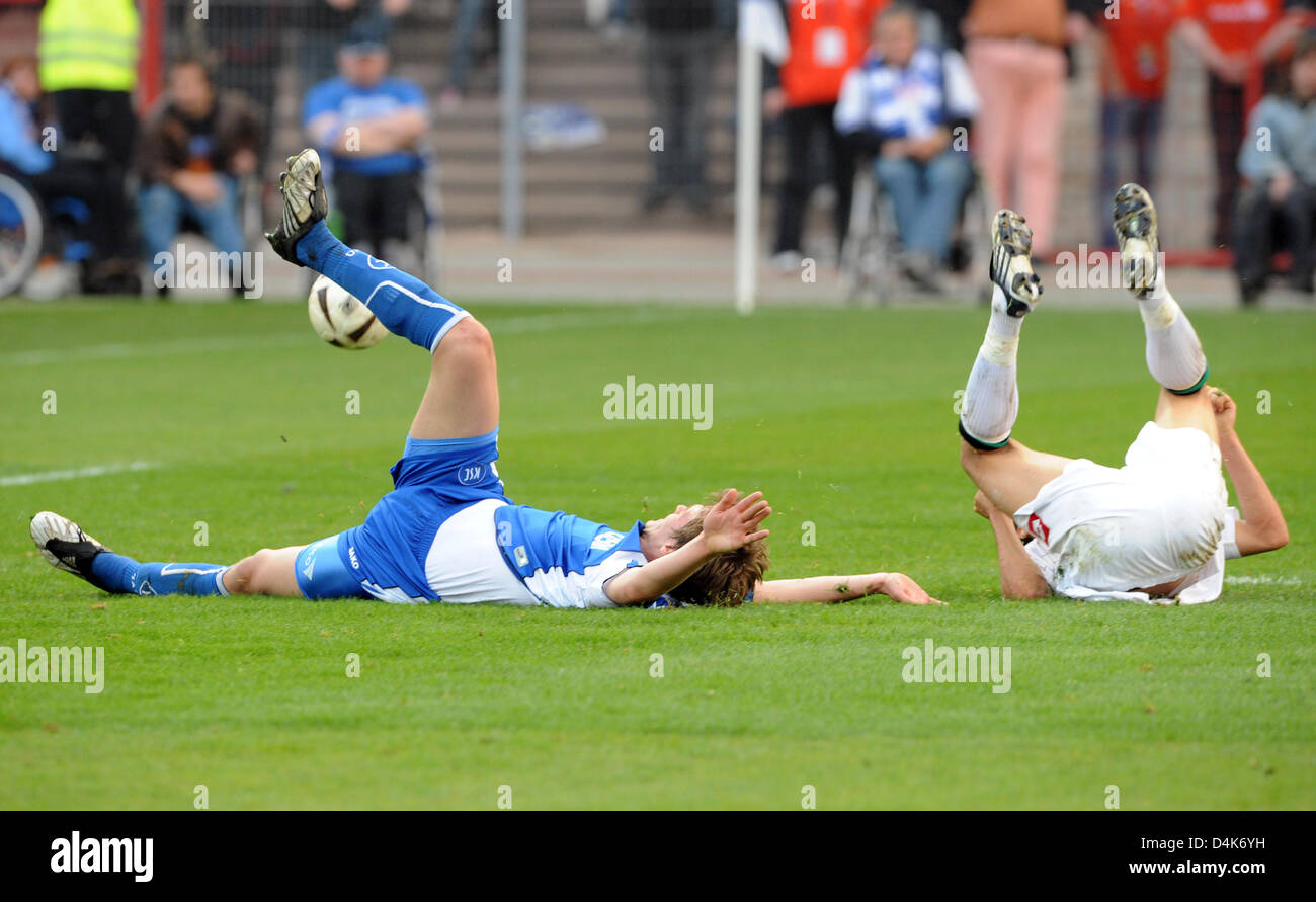 Karlsruhe?s Sebastian Langkamp (L) and Moenchengladbach?s Karim Matmour (R) lie on the pitch during the German Bundesliga match SC Karlsruhe v Borussia Moenchengladbach at Wildpark stadium of Karlsruhe, Germany, 05 April 2009. The match ended in a goalless draw. Photo: ULI DECK   (ATTENTION: EMBARGO CONDITIONS! The DFL permits the further utilisation of the pictures in IPTV, mobile Stock Photo