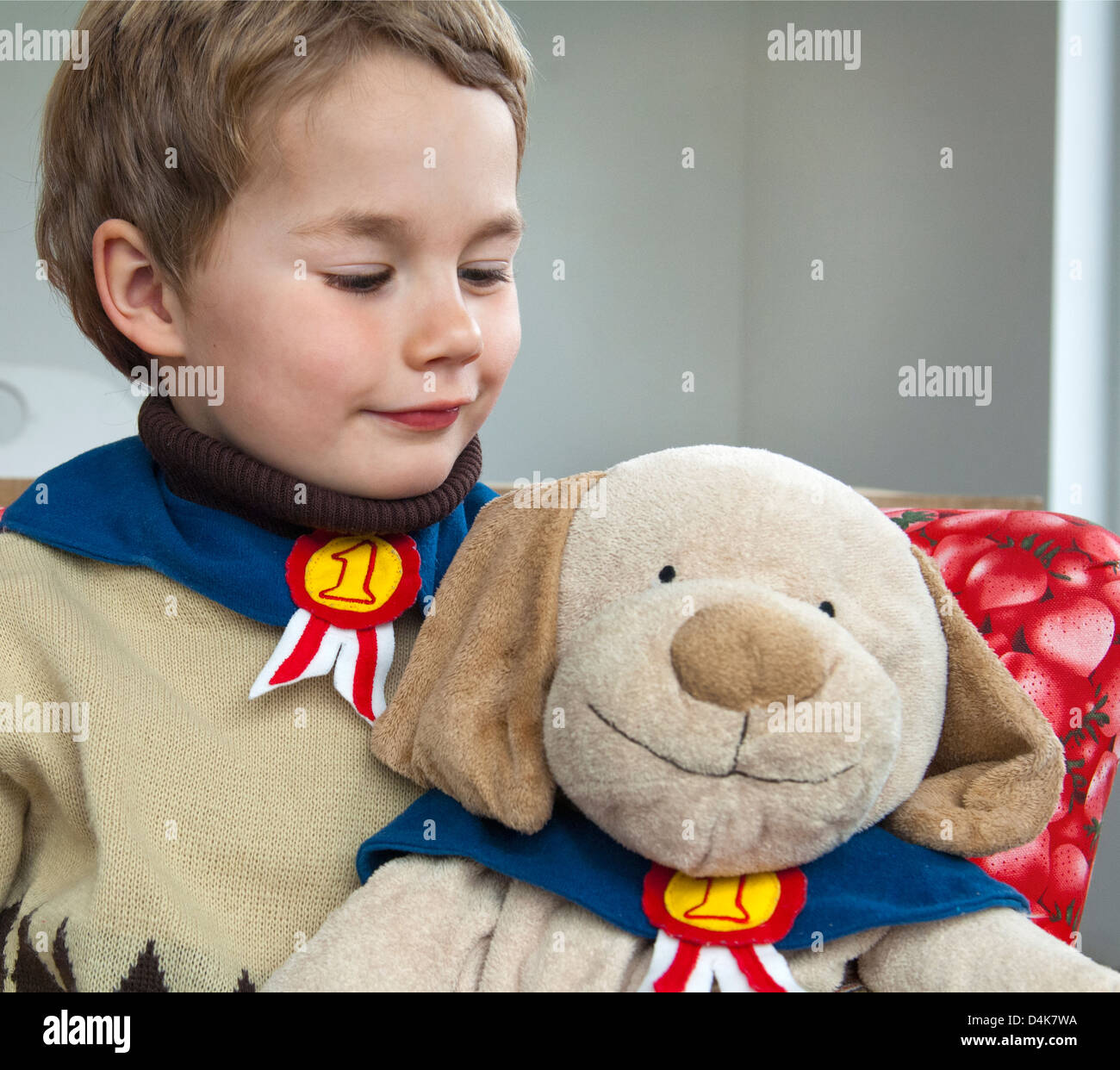 Boy playing with teddy bear Stock Photo - Alamy