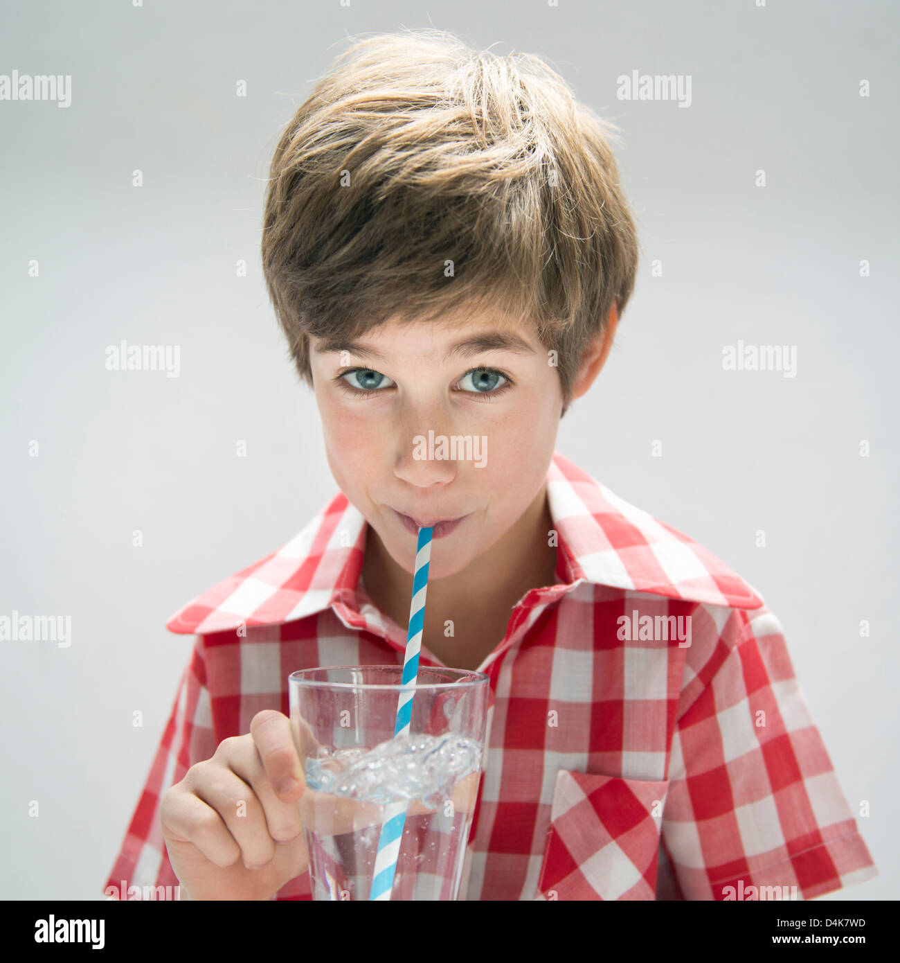 Boy drinking water with straw Stock Photo Alamy