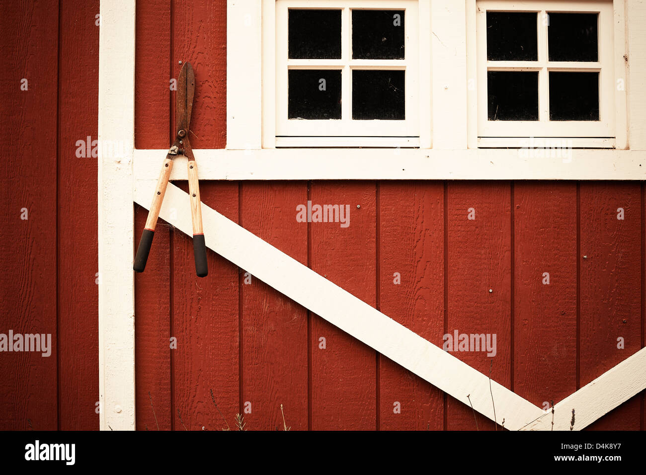 Shears hanging from barn wall Stock Photo