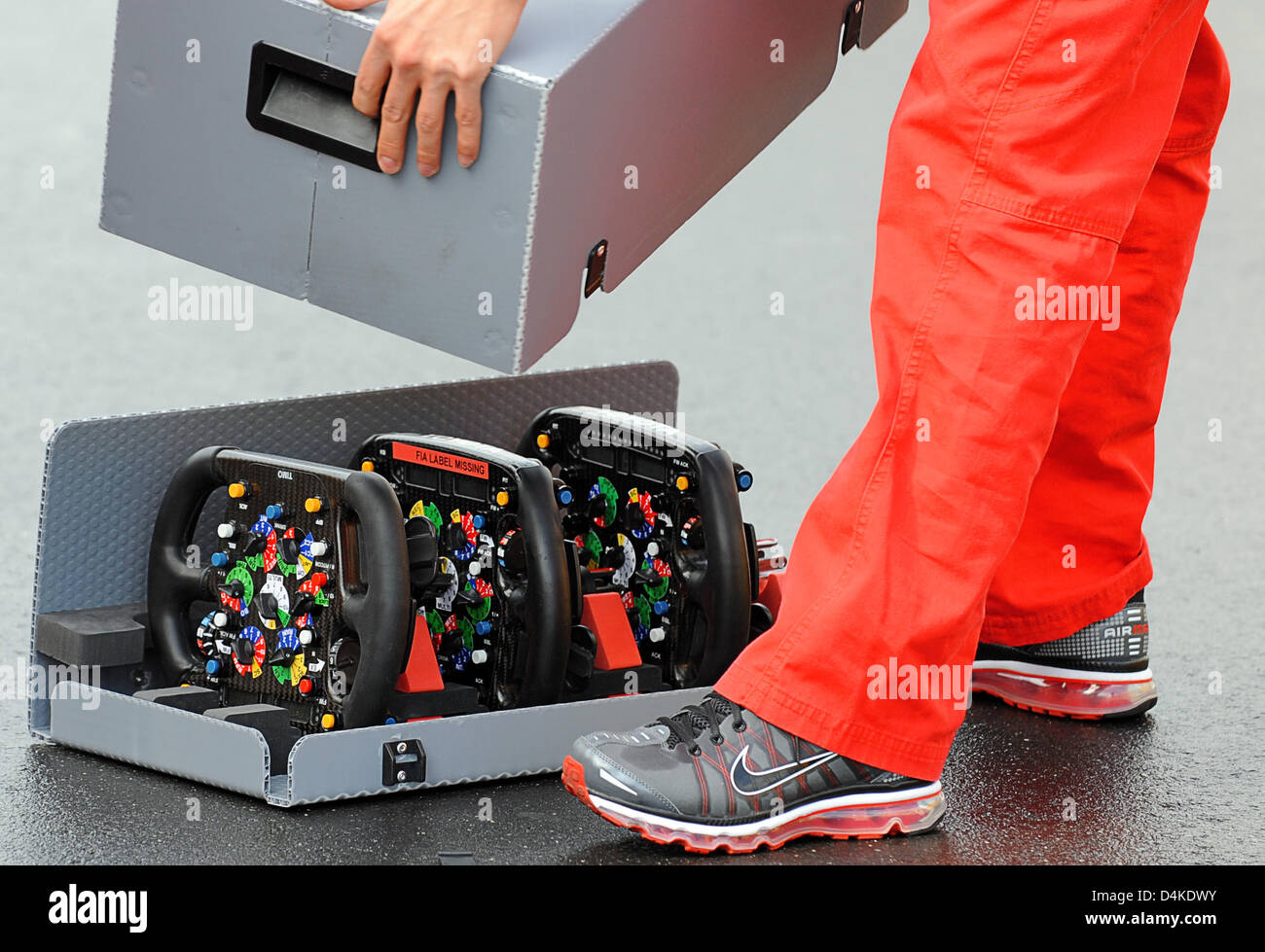 A man closes the transportation box for the steering wheels of the Toyota racing cars at Nurburgring in Nuerburg, Germany, 09 July 2009. The Formula 1 Grand Prix of Germany will take place on 12 July. Photo: Peter Steffen Stock Photo
