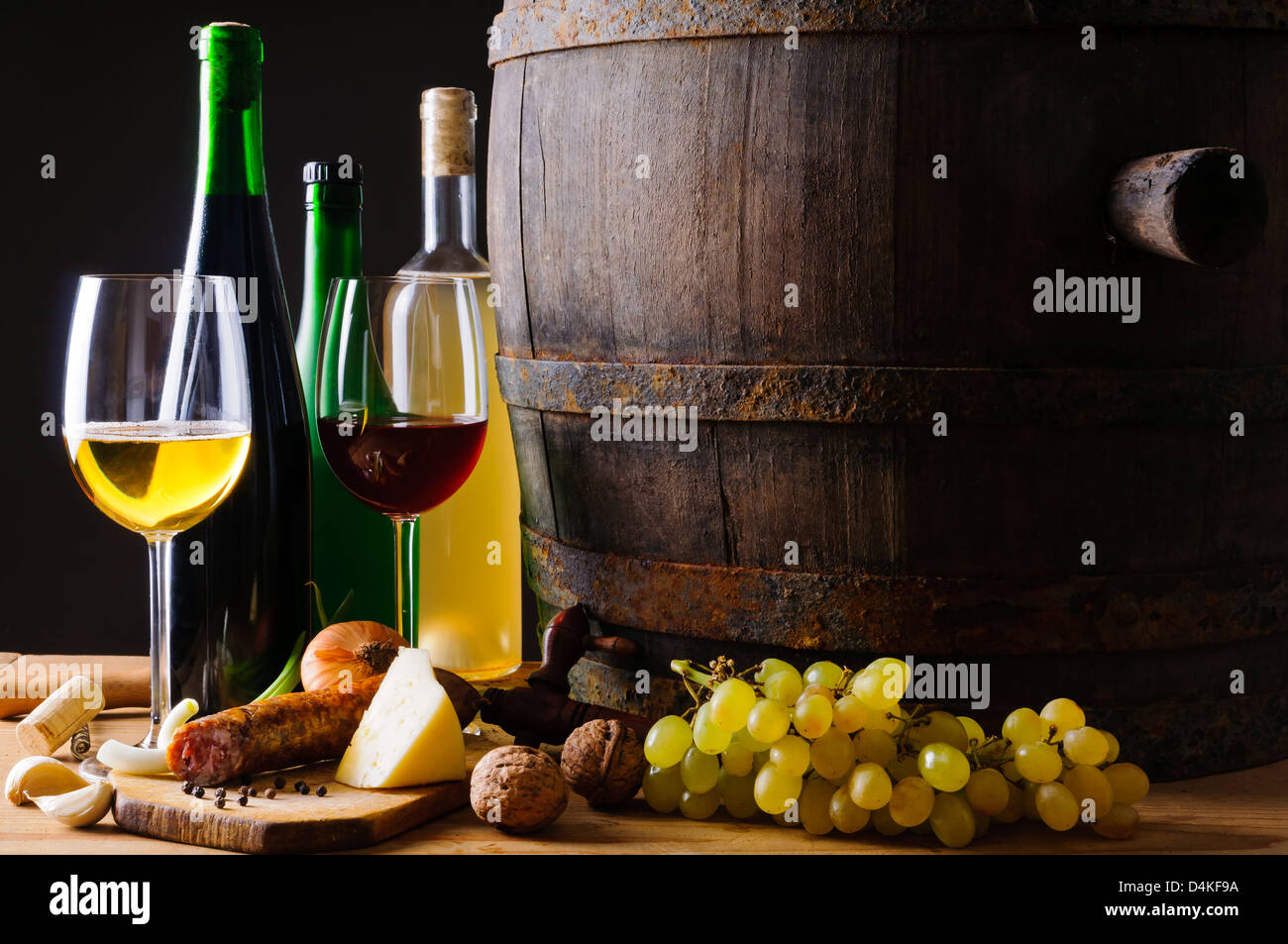 Still life composition with wine glasses, bottles and traditional food ...