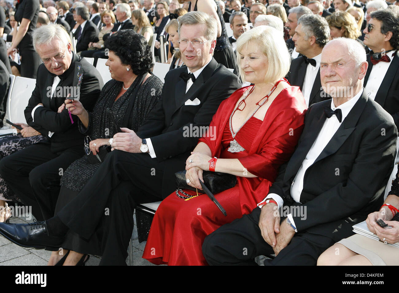 Martin Winterkorn (L-R), CEO of Volkswagen AG, his wife Anita, Christian Wulff, Prime Minister of Lower Saxony, Ursula Piech and her husband Ferdinand Piech, chairman of the board of Volkswagen, sit in the first row during the ceremonial act on the 100th anniversary of car producer Audi in Ingolstadt, Germany, 16 July 2009. Celebrities from politics, economy, culture and sports are Stock Photo