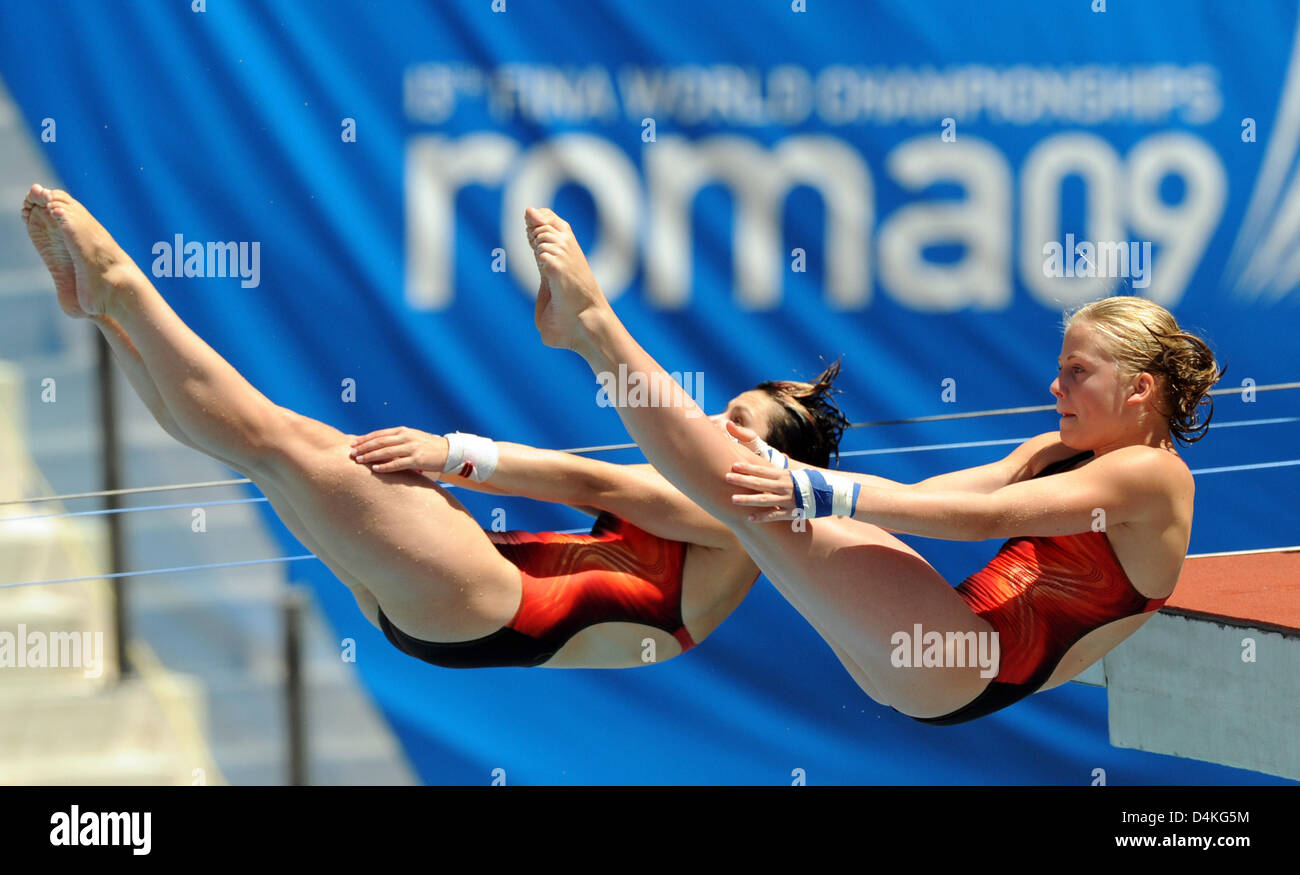 Germany?s Nora Subschinski (L) and Josephine Moeller (R) dive off the