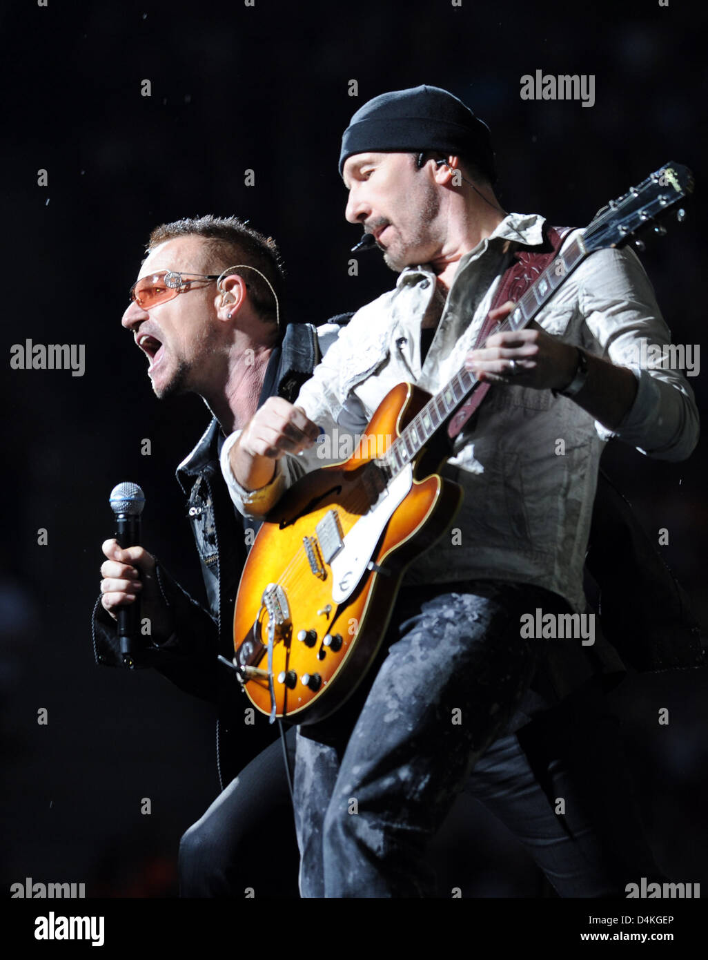 Bono (L), singer of Irish rock band U2, and guitarist ?The Edge? perform on stage during the first of two Germany concerts at the Olympic Stadium in Berlin, Germany, 18 July 2009. According to the organisers 90.000 fans flocked to the first concert of the ?360 Grad Tour? (360 degrees tour). Photo: RAINER JENSEN Stock Photo