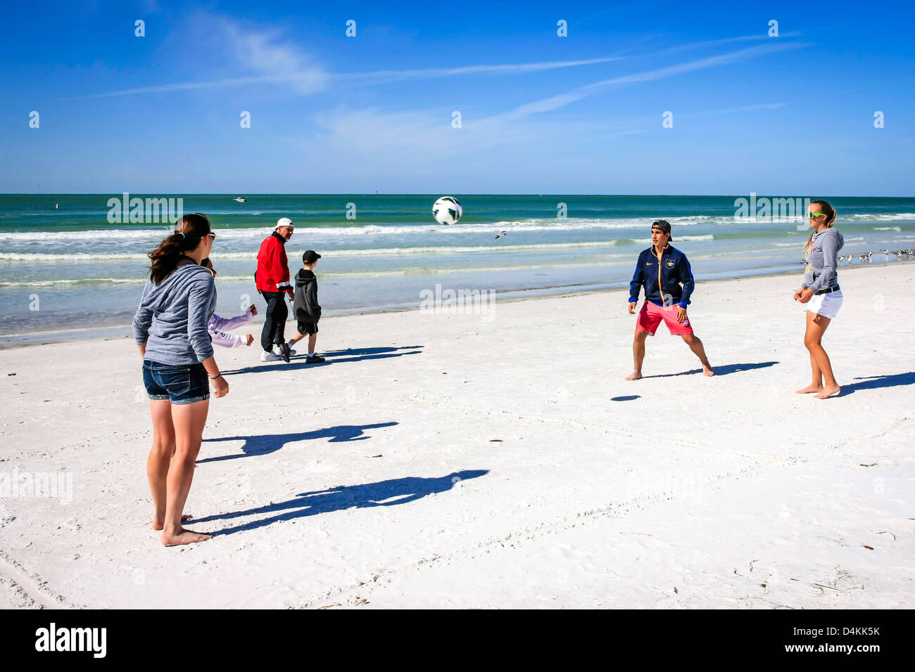 College kids on spring break playing soccer on Siesta Key beach in