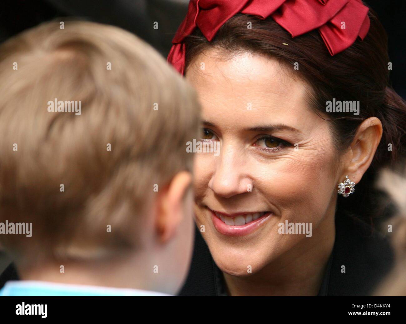 Danish Crown Princess Mary (R) talks to children as she visits a Danish