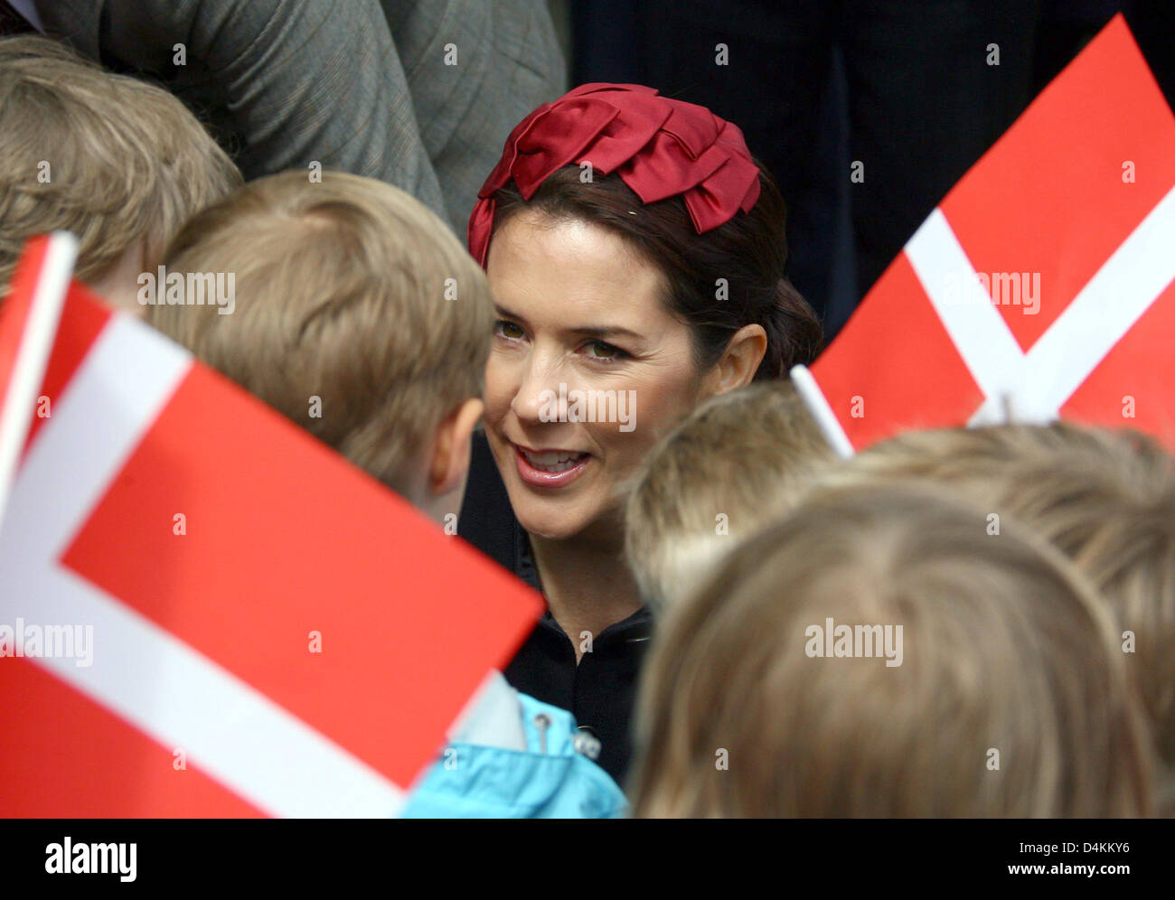 Danish Crown Princess Mary (C) talks to children as she visits a Danish