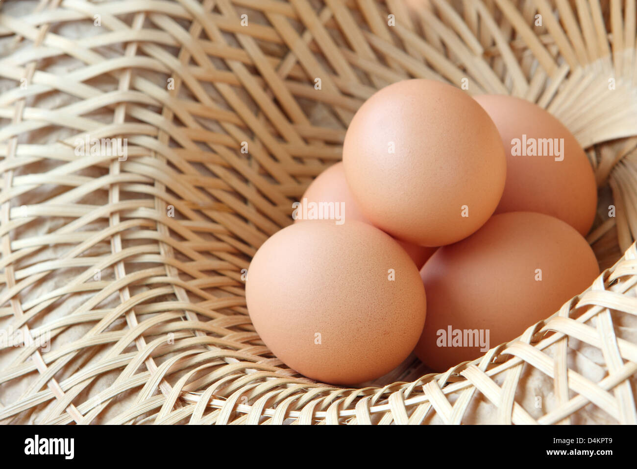 A wicker basket full of brown free range eggs Stock Photo