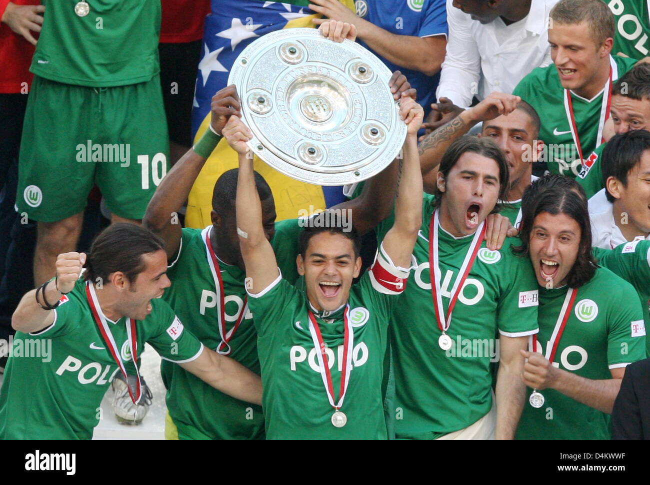 Wolfsburg?s captain Josue (C) holds the championship shield and celebrates  with the team after the Bundesliga soccer match VfL Wolfsburg vs Werder  Bremen on the last day of the 2008/2009 season at