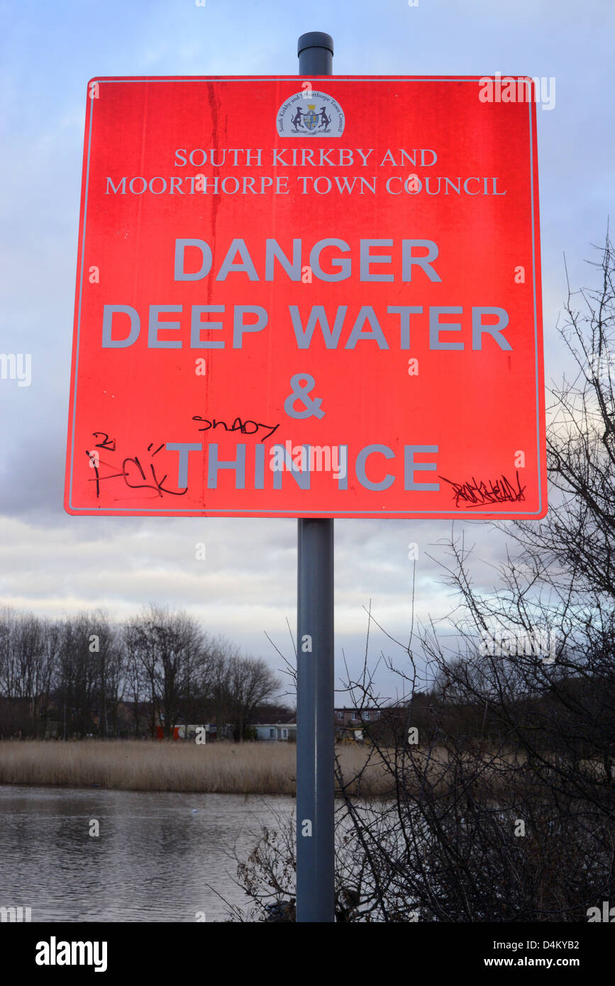warning sign of deep water and thin ice by pond Yorkshire United Kingdom Stock Photo