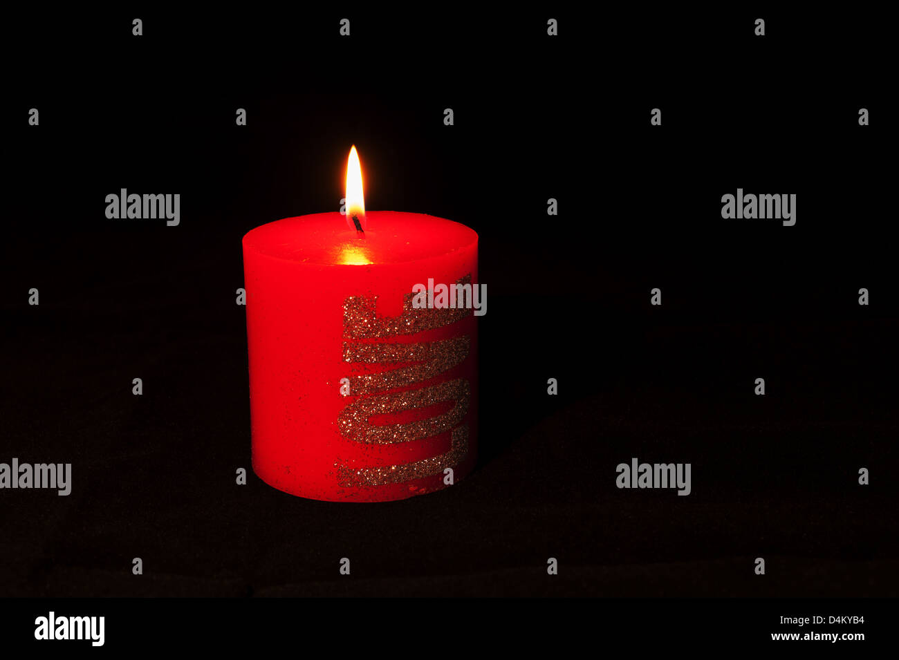 One big red candle on black background Stock Photo - Alamy