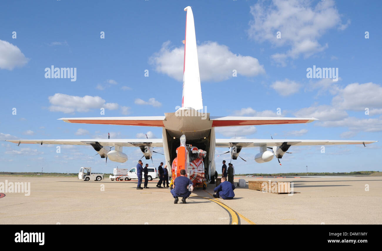 Coast Guard crews transport a MH65C Dolphin helicopter to a C130 Hercules aircraft in Atlantic
