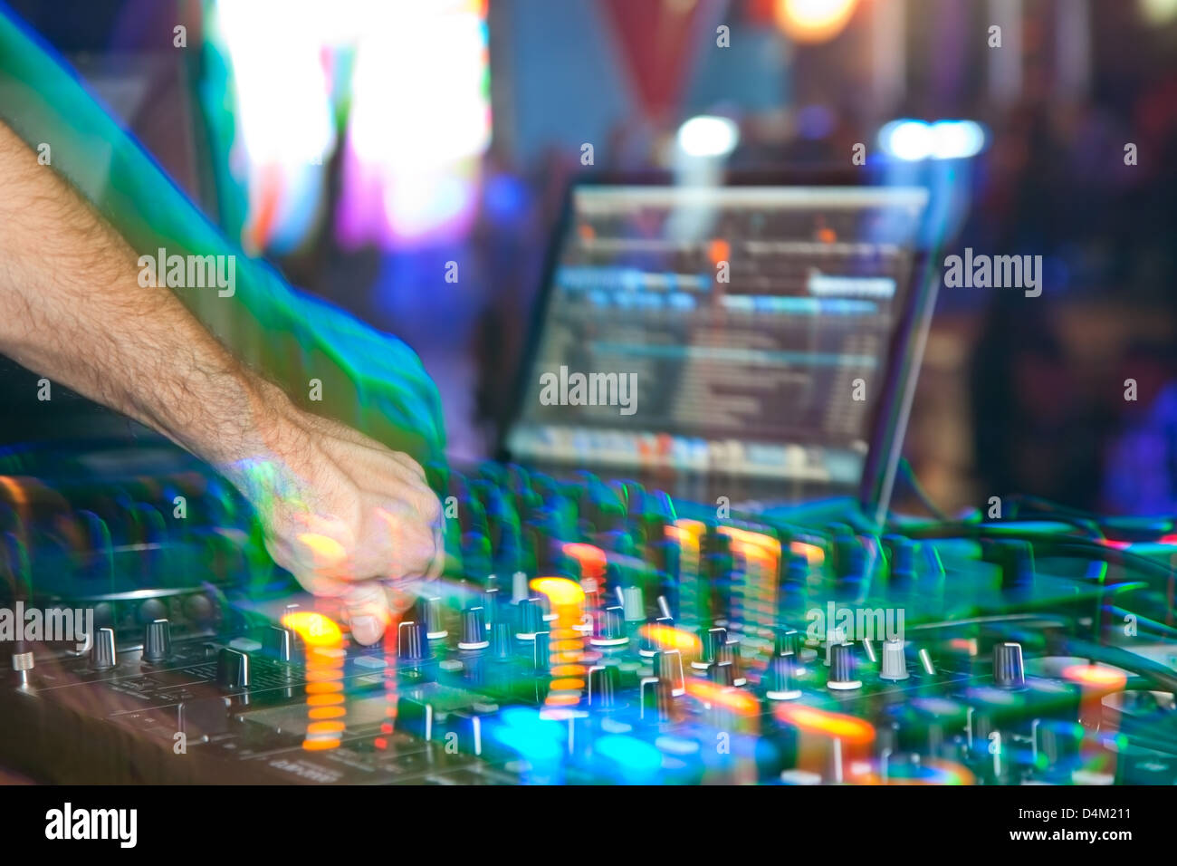 DJ behind the decks in night club Stock Photo